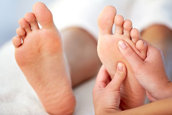 Reflexology being performed on foot